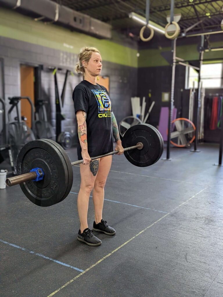 female member of Cru Fitness crossfit gym in Ponchatoula, La performing the fitness movement called deadlifts at the gym